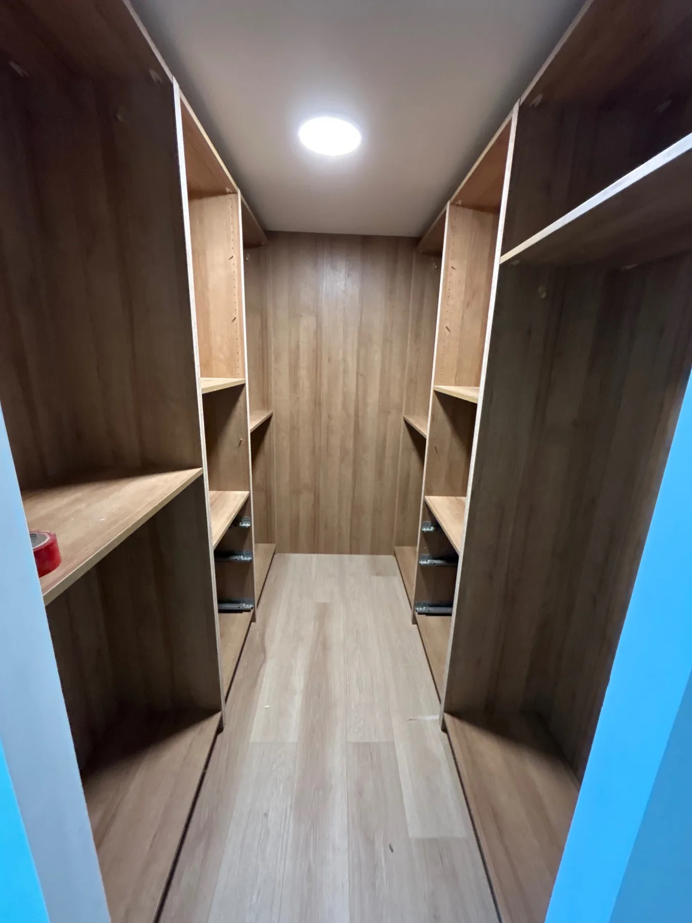 Large custom walk-in closet in warm wood finish